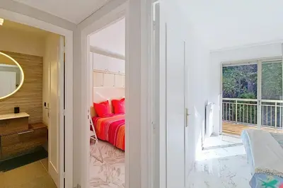 a bedroom with a bed with red pillows and a window at HENRI CAMILLE RE -Wios- 2 bedrooms APT - Huge terrace sea view in Cannes