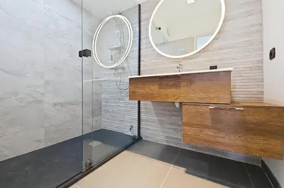 a bathroom with a sink and a mirror at HENRI CAMILLE RE -Wios- 2 bedrooms APT - Huge terrace sea view in Cannes
