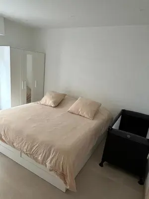 a bedroom with a bed with a mirror and a dresser at Joyaux cannois in Cannes
