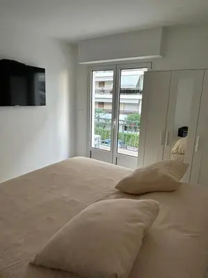 a bedroom with a large bed with pillows on it at Joyaux cannois in Cannes