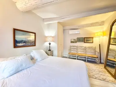 a bedroom with a white bed and two chairs at Elegant studio à Cannes - Suquet - 2 people in Cannes