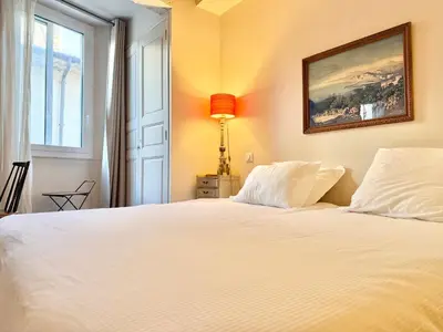 a bedroom with a white bed and a window at Elegant studio à Cannes - Suquet - 2 people in Cannes