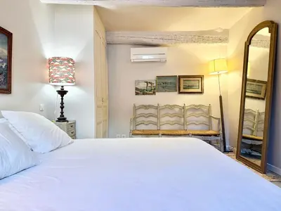 a bedroom with a white bed and a mirror at Elegant studio à Cannes - Suquet - 2 people in Cannes