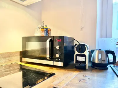 a microwave sitting on top of a kitchen counter at Elegant studio à Cannes - Suquet - 2 people in Cannes