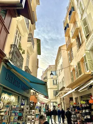 a group of people walking down a street with a book store at Top floor apartment in Cannes