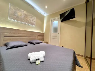 a bedroom with a bed with two towels on it at Suquet apartment cosy et charming in Cannes