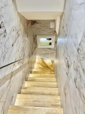 a staircase in a room with marble walls at Suquet apartment cosy et charming in Cannes