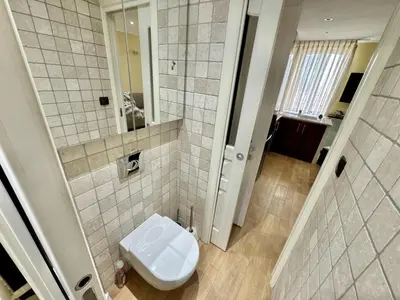 a small bathroom with a toilet and a mirror at Suquet apartment cosy et charming in Cannes