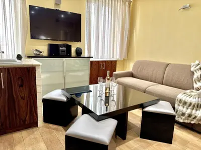 a living room with a couch and a table at Suquet apartment cosy et charming in Cannes
