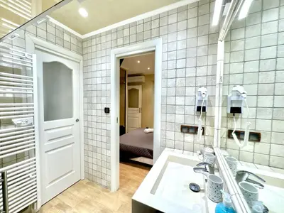 a bathroom with a sink and a mirror at Suquet apartment cosy et charming in Cannes