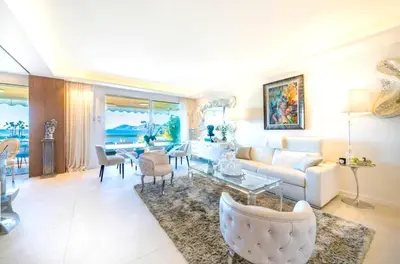a bedroom with a large bed and a window at Mon Croisettee in Cannes