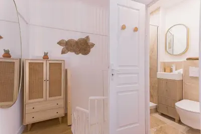 a white bathroom with a toilet and a sink at Azur Loft Beauséjour Heart of Cannes in Cannes