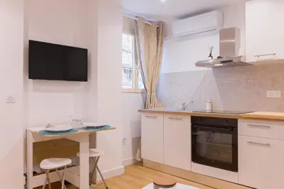 a kitchen with a sink and a desk in it at Azur Loft Beauséjour Heart of Cannes in Cannes