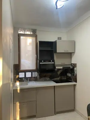 a kitchen with a sink and a microwave at Studio climatisé 5 min centre Cannes in Cannes