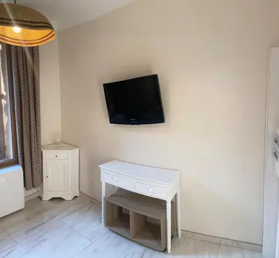 a living room with a tv on the wall at Studio climatisé 5 min centre Cannes in Cannes
