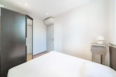 a bedroom with a bed and a closet at Cozystay 1802 One bedroom in the Heart of Cannes in Cannes