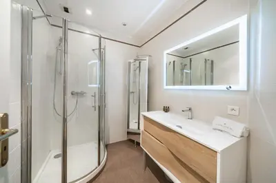 a bathroom with a shower and a sink and a mirror at Cozystay 1802 One bedroom in the Heart of Cannes in Cannes