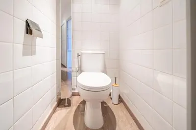 a bathroom with a white toilet in a stall at Cozystay 1802 One bedroom in the Heart of Cannes in Cannes