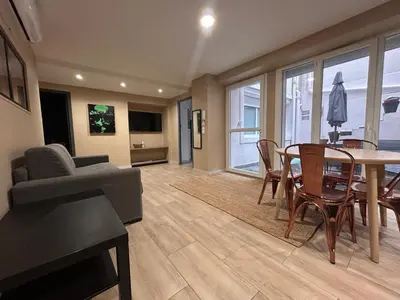 a living room with a table and a dining room at Superbe 4P, 3 Ch, 2 SDB, Proche Palais et Plages in Cannes