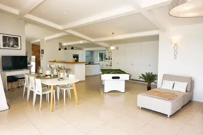 a kitchen and living room with a table and chairs at Ref JOA - Palmes d Or Properties in Cannes