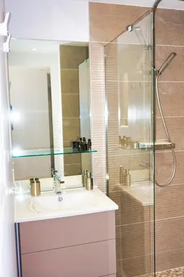 a bathroom with a sink and a glass shower at Ref JOA - Palmes d Or Properties in Cannes