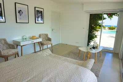 a bedroom with a bed and a table and a window at Ref JOA - Palmes d Or Properties in Cannes