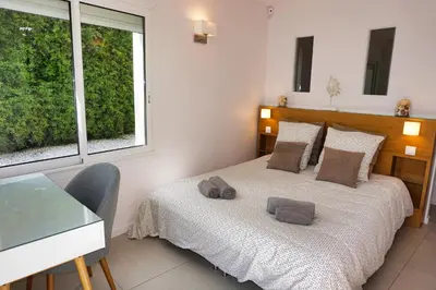 a bedroom with a bed and a desk and a window at Ref JOA - Palmes d Or Properties in Cannes