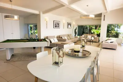 a living room with a table and a pool table at Ref JOA - Palmes d Or Properties in Cannes