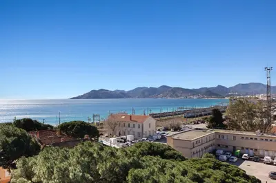 a view of the ocean from a building at Le RivieraPeacefulSwimming poolCar parkSeafront in Cannes