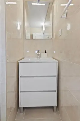 a bathroom with a white sink and a mirror at Le RivieraPeacefulSwimming poolCar parkSeafront in Cannes
