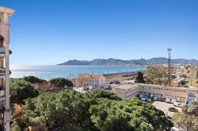 a view of a city with the ocean in the background at Le RivieraPeacefulSwimming poolCar parkSeafront in Cannes