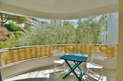 a blue table and chairs on a balcony at Studio BELLA VISTA avec parking in Le Cannet