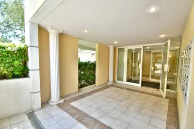 an empty hallway of a house with columns at Studio BELLA VISTA avec parking in Le Cannet