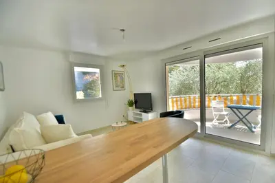 a living room with a couch and a table at Studio BELLA VISTA avec parking in Le Cannet