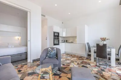 a living room with a couch and a table and a bed at 2 chambres-BALCON-VUE MER-FELIX FAURE A2B231 in Cannes
