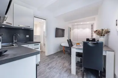a kitchen with a table and a dining room at 2 pièces Moderne FELIX FAURE-VIEUX PORT A1B232 in Cannes