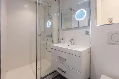 a white bathroom with a sink and a shower at 2 pièces Moderne FELIX FAURE-VIEUX PORT A1B232 in Cannes