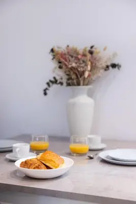 a table with a plate of food and orange juice at 2 pièces Moderne FELIX FAURE-VIEUX PORT A1B232 in Cannes
