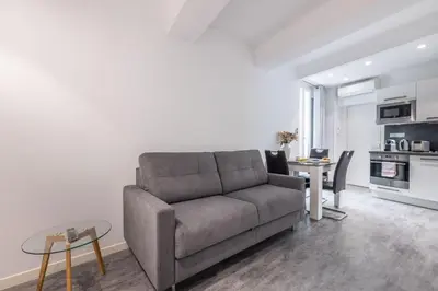 a living room with a couch and a table at 2 pièces Moderne FELIX FAURE-VIEUX PORT A1B232 in Cannes