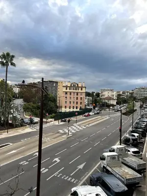 a city street with cars parked on the side of a road at Charmant studio en centre ville in Le Cannet