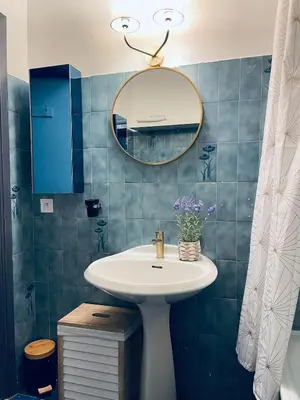 a bathroom with a sink and a mirror at Charmant studio en centre ville in Le Cannet