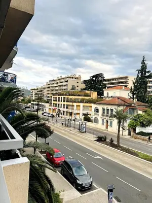 two cars parked on the side of a city street at Charmant studio en centre ville in Le Cannet