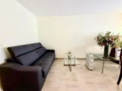 a living room with a couch and a glass table at Gray studio D vue mer in Cannes