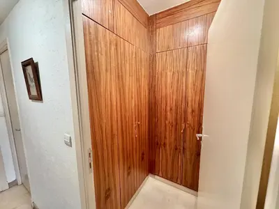 a bathroom with a wooden door in a room at Gray studio D vue mer in Cannes