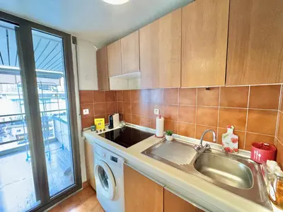 a kitchen with a sink and a washing machine at Gray studio D vue mer in Cannes