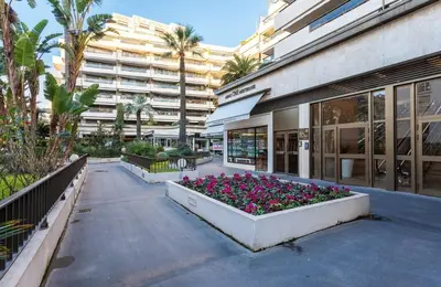 a building with a bunch of flowers in front of it at Gray studio D vue mer in Cannes