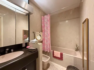 a bathroom with a sink and a toilet and a tub at Gray studio D vue mer in Cannes