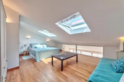 a bedroom with a bed and a couch and a skylight at DUPLEX 2 chambres -TERRASSE Vue MER-FELIX FAURE A2B024 in Cannes