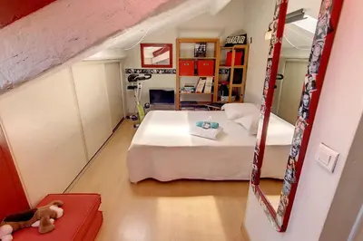 a small bedroom with a bed and a mirror at HENRI CAMILLE REAL ESTATE - ROOF - 2 bedrooms downtown w rooftop in Cannes