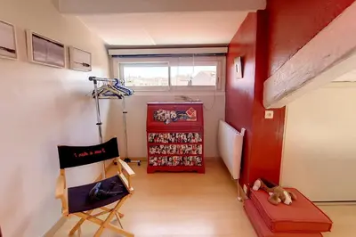 a hallway with a red room with a dog laying on the floor at HENRI CAMILLE REAL ESTATE - ROOF - 2 bedrooms downtown w rooftop in Cannes